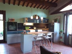 a kitchen with a table and chairs in a room at I Tamerici in Saludecio