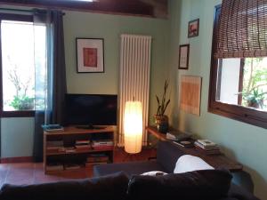 a living room with a couch and a flat screen tv at I Tamerici in Saludecio