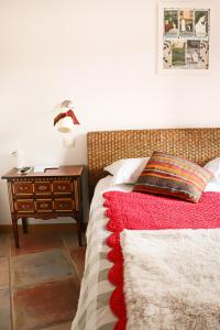 a bedroom with a bed and a nightstand with a red blanket at A La Villa Boucicaut in Chalon-sur-Saône