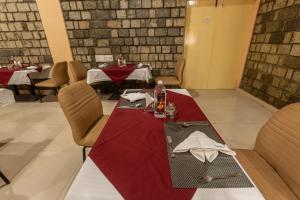 a table in a restaurant with a red table cloth at KSTDC Mayura Durg Chitradurga in Chitradurga