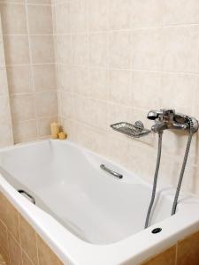 a white bath tub with a faucet in a bathroom at Goldy's Villa in Roussospítion