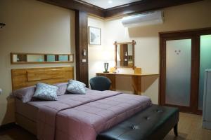 a bedroom with a large bed and a desk at Little Guest House Hotel in Chiang Mai +57 photos