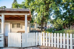 a white picket fence in front of a house at Etzel Tami Hospitality in Neot Golan