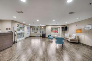 a waiting room with a couch and a table at Sleep Inn & Suites in Decatur