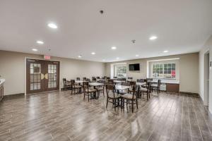 a restaurant with tables and chairs in a room at Sleep Inn & Suites in Decatur