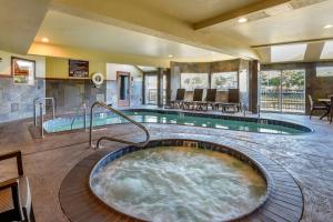 a hot tub in the middle of a hotel room at Kathryn Riverfront Inn, Ascend Hotel Collection in Seaside