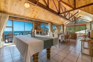 a dining room with a table and a view of the ocean at Auberge Cape Guesthouse in Cape Town
