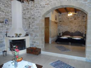 a living room with a fireplace and a couch at Sivas Apartments-Studios,Sigelakis with very nice view in Sívas