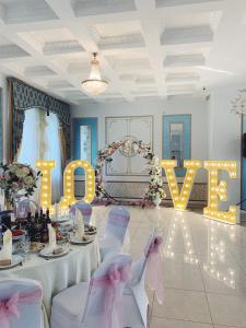 a room with a table with a sign that reads love at Hotel Golden Night in Kaliningrad
