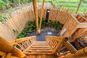 an overhead view of a wooden staircase with benches at IPIAN Jiwa by Pramana Villas in Ubud