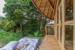 a porch of a house with a wooden deck at IPIAN Jiwa by Pramana Villas in Ubud