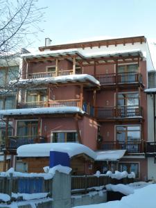 a building with snow on the ground in front of it at Appartement Gurgl in Obergurgl