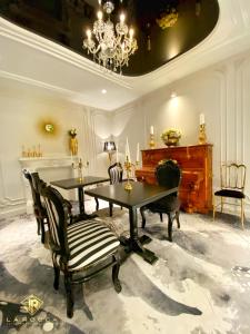 a dining room with a table and a piano at La Rocca Boutique Hotel in Craiova