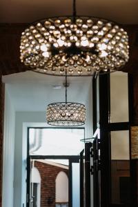 a chandelier hanging from a ceiling in a room at Hotel 32 Kraków Old Town in Krakow