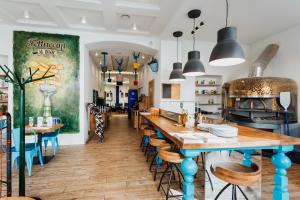 a restaurant with a long table and chairs at Hotel 32 Kraków Old Town in Krakow