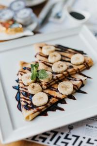 a plate of food with bananas on top at Hotel 32 Kraków Old Town in Krakow +23 photos