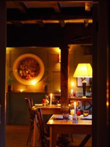 a table in a kitchen with candles on it at The Greyhound on the Test Hotel in Stockbridge