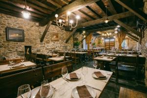 um restaurante com mesas e cadeiras num quarto em La Moncloa de San Lazaro em Cacabelos