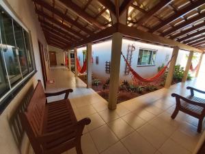 a porch with two benches on a house at Pousada DuKalango in Caldas Novas