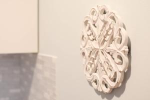 a wall sculpture of a flower on a wall at {Cloud 9} Luxury 2 Bedroom Condo in Uptown Charlotte in Charlotte