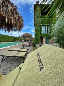 a resort with a swimming pool and a building at Bertoletta Village Apartments in Peschiera del Garda