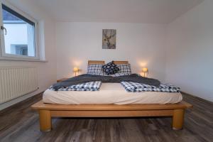 een slaapkamer met een groot bed met 2 lampen bij Lindes Appartement in Umhausen