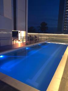The swimming pool at or close to Apartamento no 20º andar Barra Home Stay