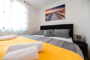 a bedroom with a large bed and a painting on the wall at Kailani Luxury Central 3 Bedroom, 3 Bathroom Apartment With a Sunny Balcony in Zadar