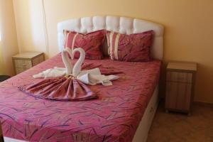 a bed with two swans made out of towels at Viva Beach Hotel in Pomorie