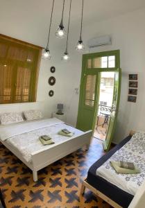 a bedroom with two beds and a green door at Apartments COMFY - for a quiet family holiday in Haifa