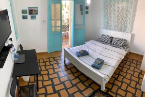 a bedroom with a bed with two pillows on it at Apartments COMFY in Haifa