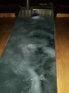 a pool of water on a wooden floor at LIVADA AMELY in Galeş