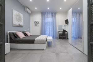 a bedroom with a bed and a desk in it at Dante Square in Naples