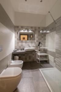 a bathroom with a tub and a toilet and a sink at Dante Square in Naples +71 photos