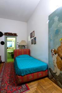 a bedroom with a bed with a dog standing next to it at Cleopatra B&B in Palermo
