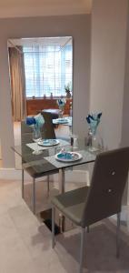 a dining room with a glass table and a mirror at 51 Cocoa Suites,Rowntrees Wharf in York