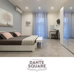 a bedroom with a bed and a table and a desk at Dante Square in Naples