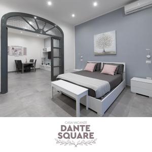 a bedroom with a bed with a table and a mirror at Dante Square in Naples