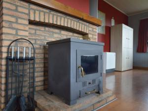 a brick fireplace with a stove in a room at Elegant Chalet in Malmedy with Private Garden in Malmedy