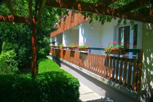 a balcony with potted plants on the side of a building at Pergola Panzió in Balatonföldvár
