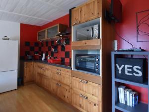 een keuken met houten kasten en een witte koelkast bij Villa with pool in L zignan Corbi res in Lézignan-Corbières