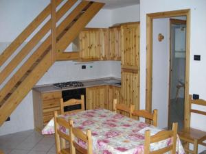 een keuken met een tafel en een keuken met een trap bij Belvilla by OYO GrBe Bilo in Antey-Saint-André