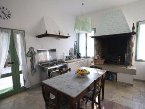 a kitchen with a table with a bowl of fruit on it at Belvilla by OYO Villa Fiorita Tre in Romano D'Ezzelino