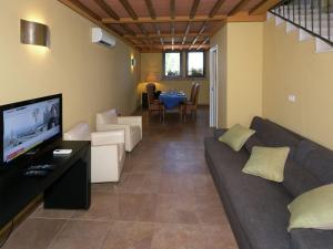 a living room with a couch and a flat screen tv at Quaint Holiday Home in Grosseto with Beach Nearby in Grosseto