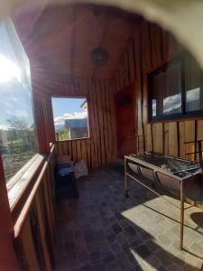 a room with a bed in a wooden room at Cabaña San Pedro in Malalcahuello