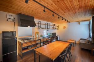 a kitchen and dining room with a wooden table at Fujiyasan in Fujikawaguchiko