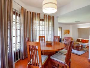 a dining room with a table and chairs at Lovely villa in Vilamoura with private pool in Vilamoura