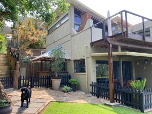 a black dog standing in front of a house at Billfish Apartments in Ballito