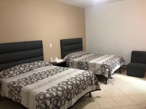Postel nebo postele na pokoji v ubytování Hotel Posada Ruiseñor