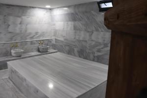 a bathroom with two sinks in a stone wall at Mes Hotel & Spa in Samsun +65 photos
